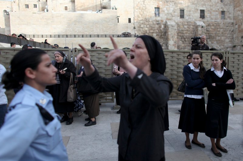 Orthodox Jewish women protest against a group of Jewish women who call them...